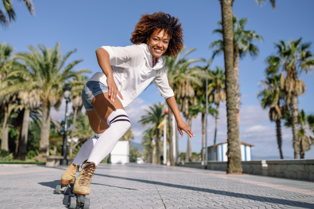 African American woman roller skating and smiling